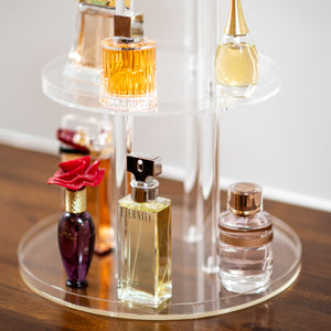 perfume displayed on clear acrylic stand