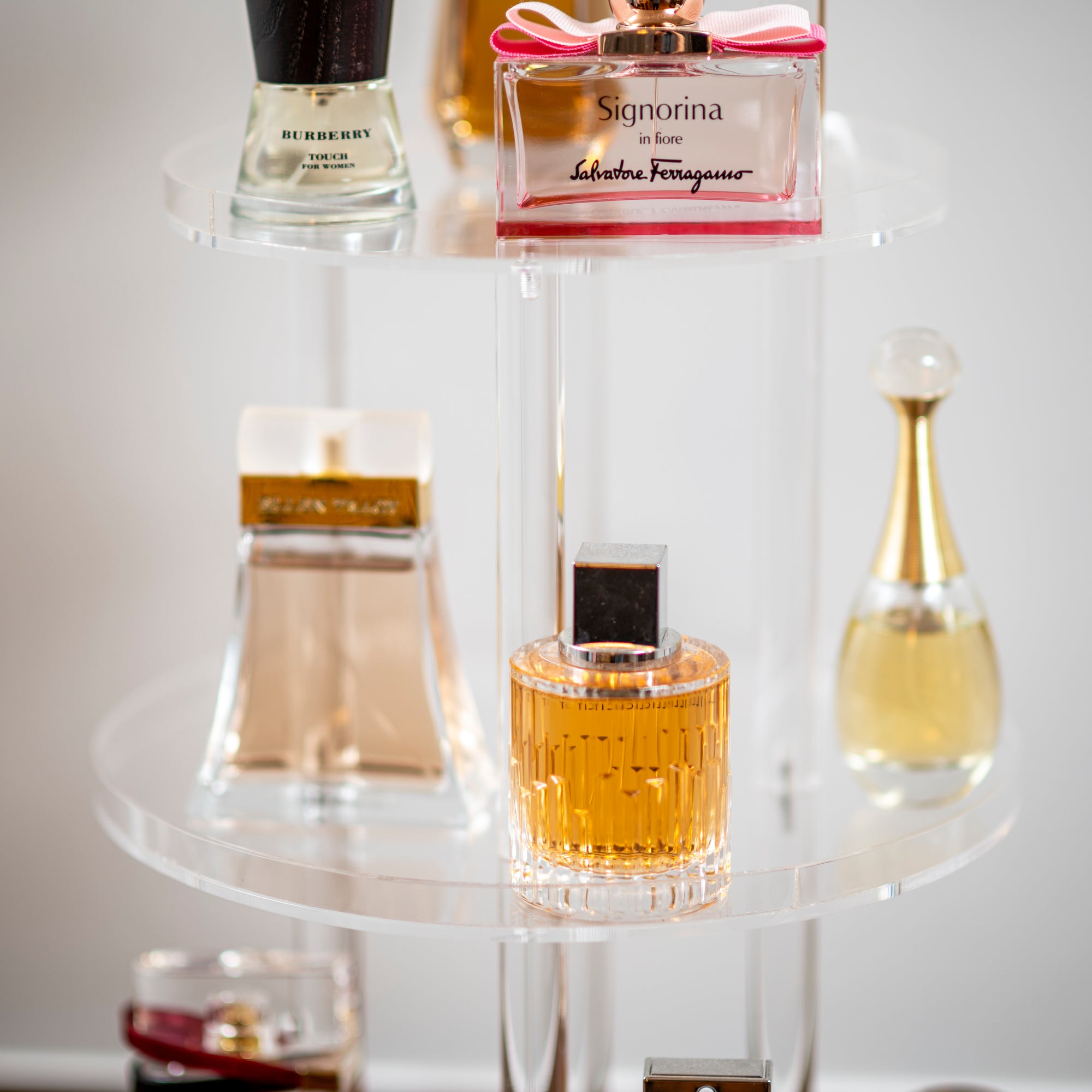 perfume bottles on clear acrylic perfume stand 