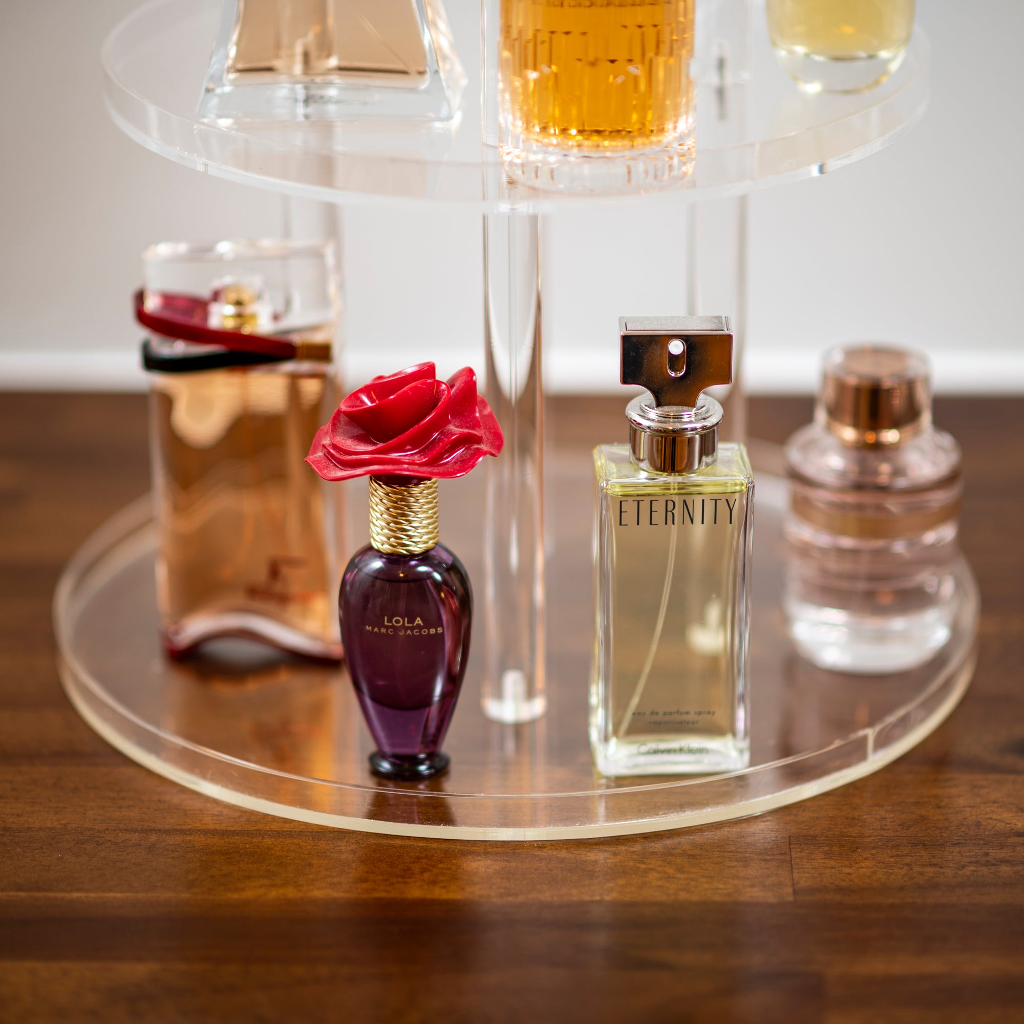 rounded acrylic perfume stand with perfume collection 